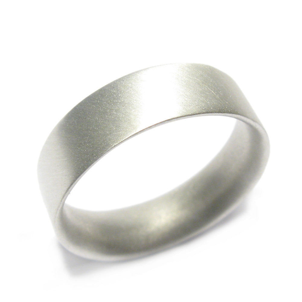 Wide, men's 9ct white gold ring displayed on white background