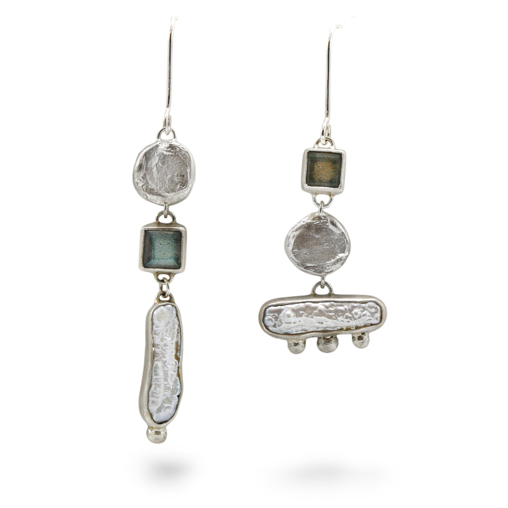 Silver earrings with natural stone-like elements on a white background