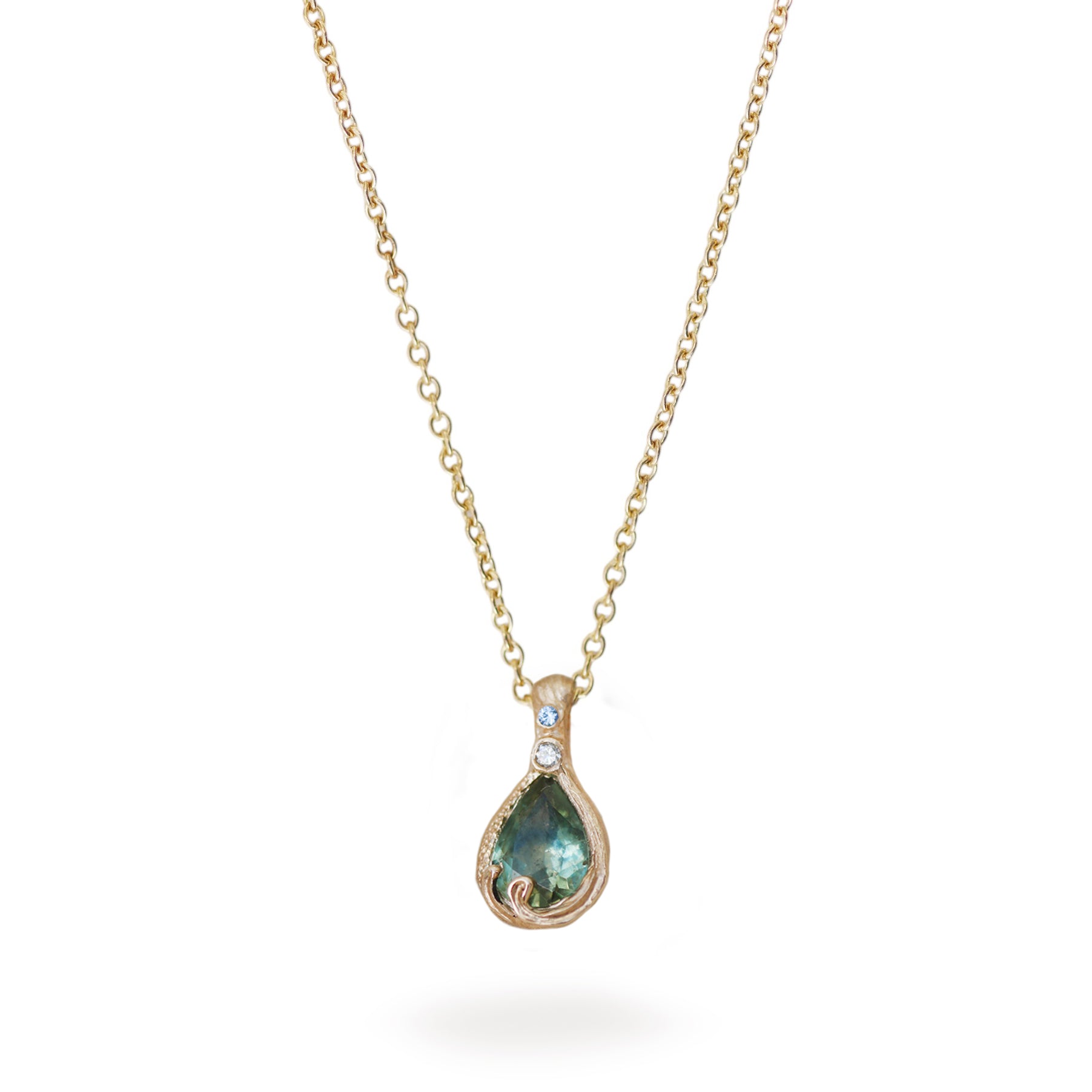 Teal green pear shaped Stone set in yellow gold pendant on a white background