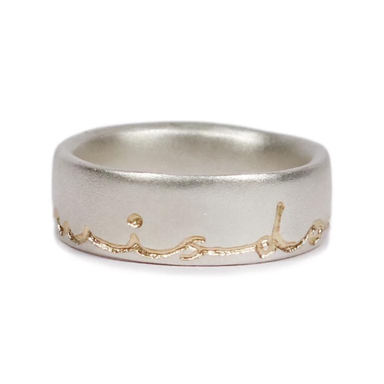 Modern Silver Ring etched with handwritten wisdom of life in yellow gold etching on a white background