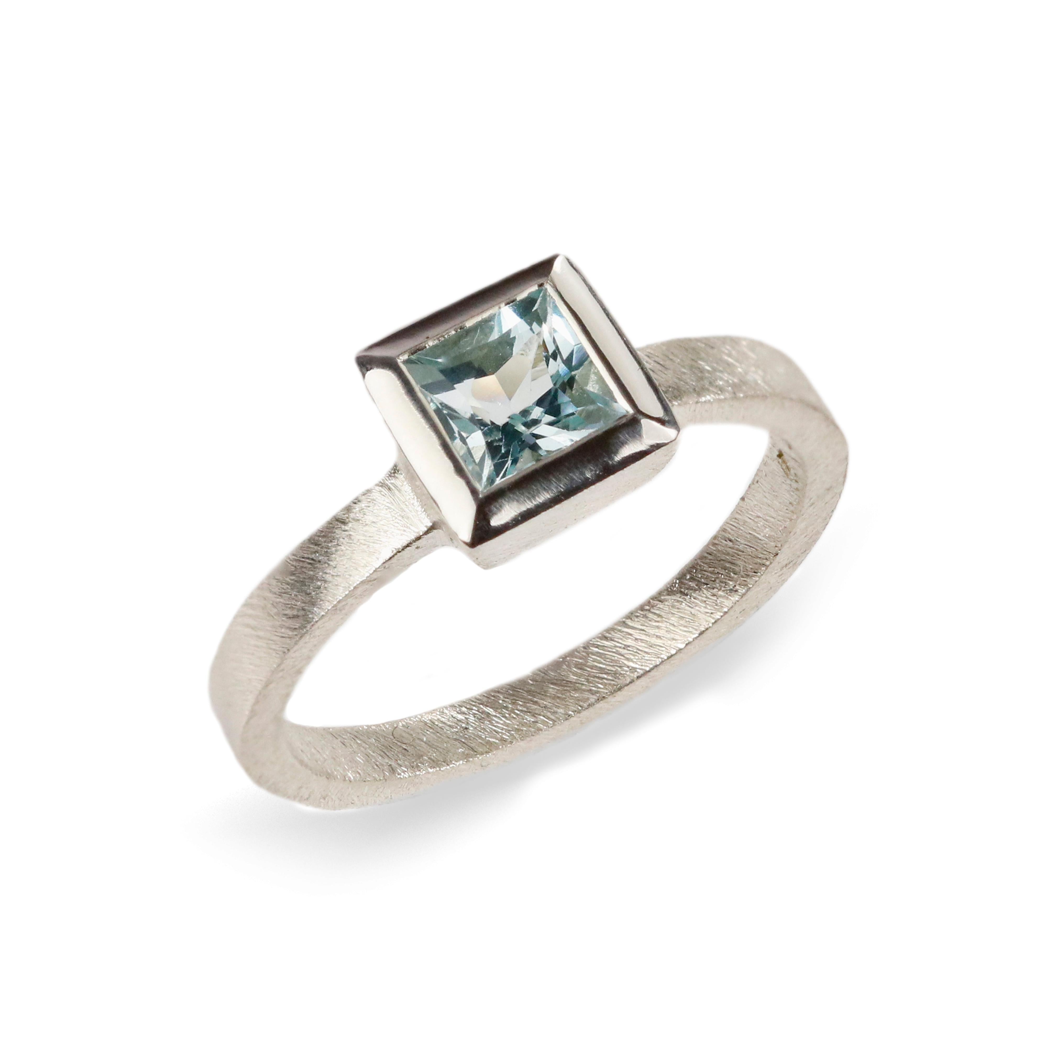 White Gold Ring with Blue Princess Cut Aquamarine  on white background 