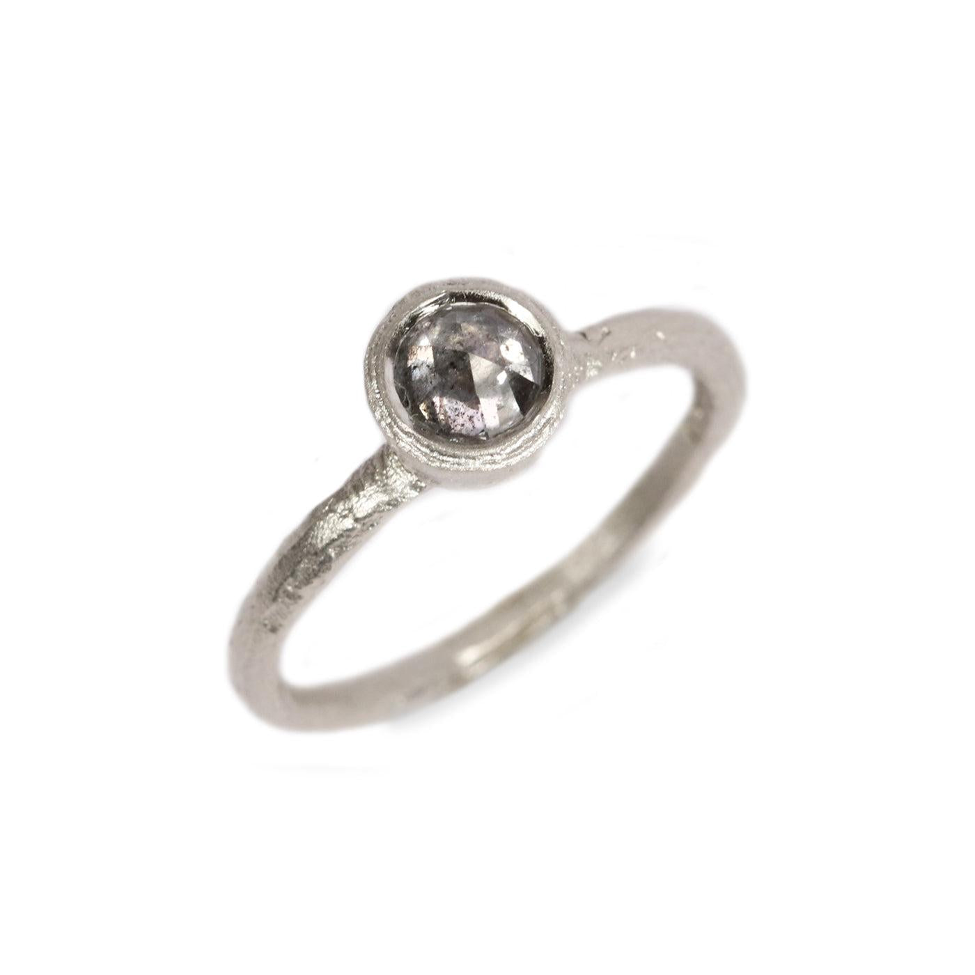 Textured White Gold set with a Grey Rose Cut Diamond on white background 