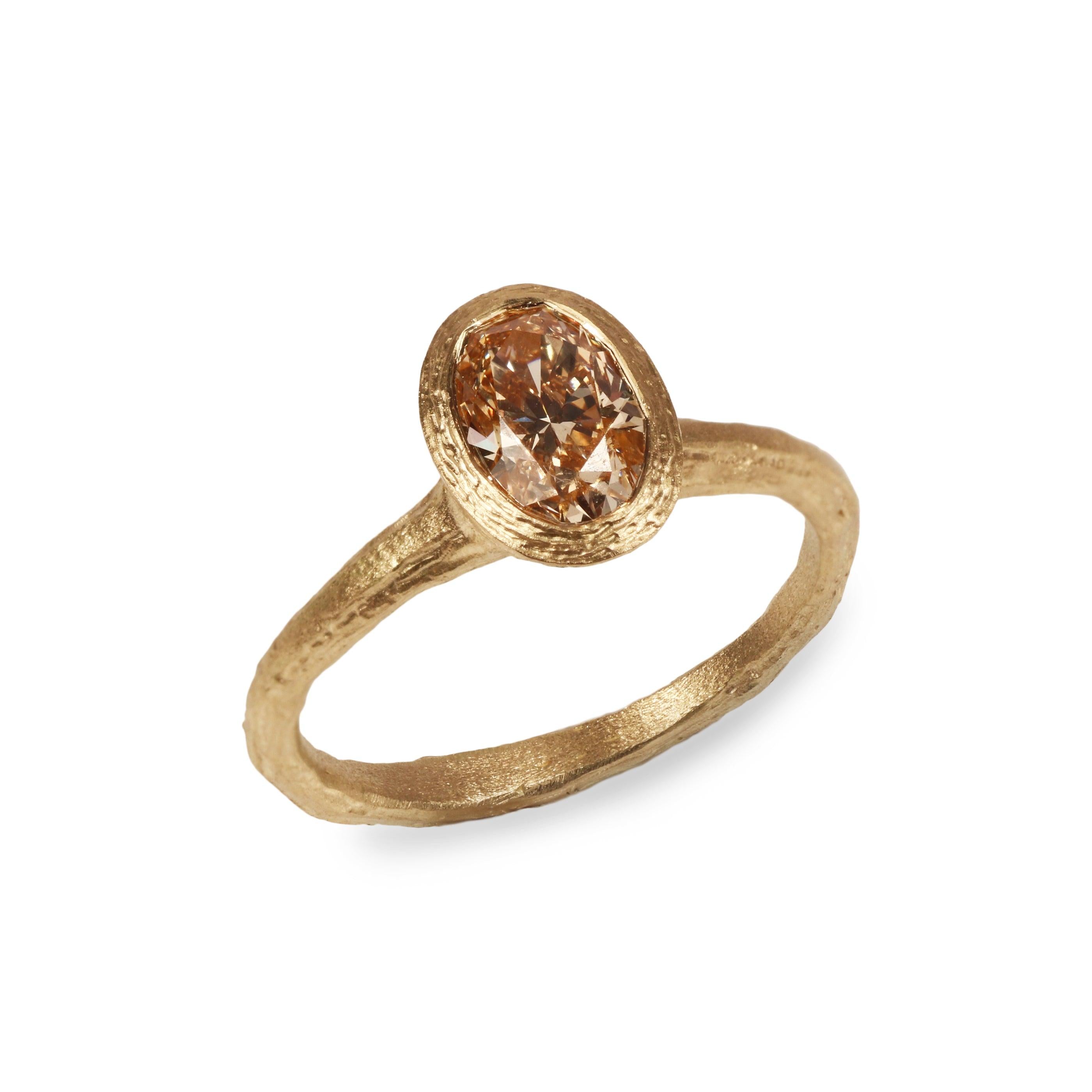Yellow Gold Ring with Oval Champagne Diamond on white background 