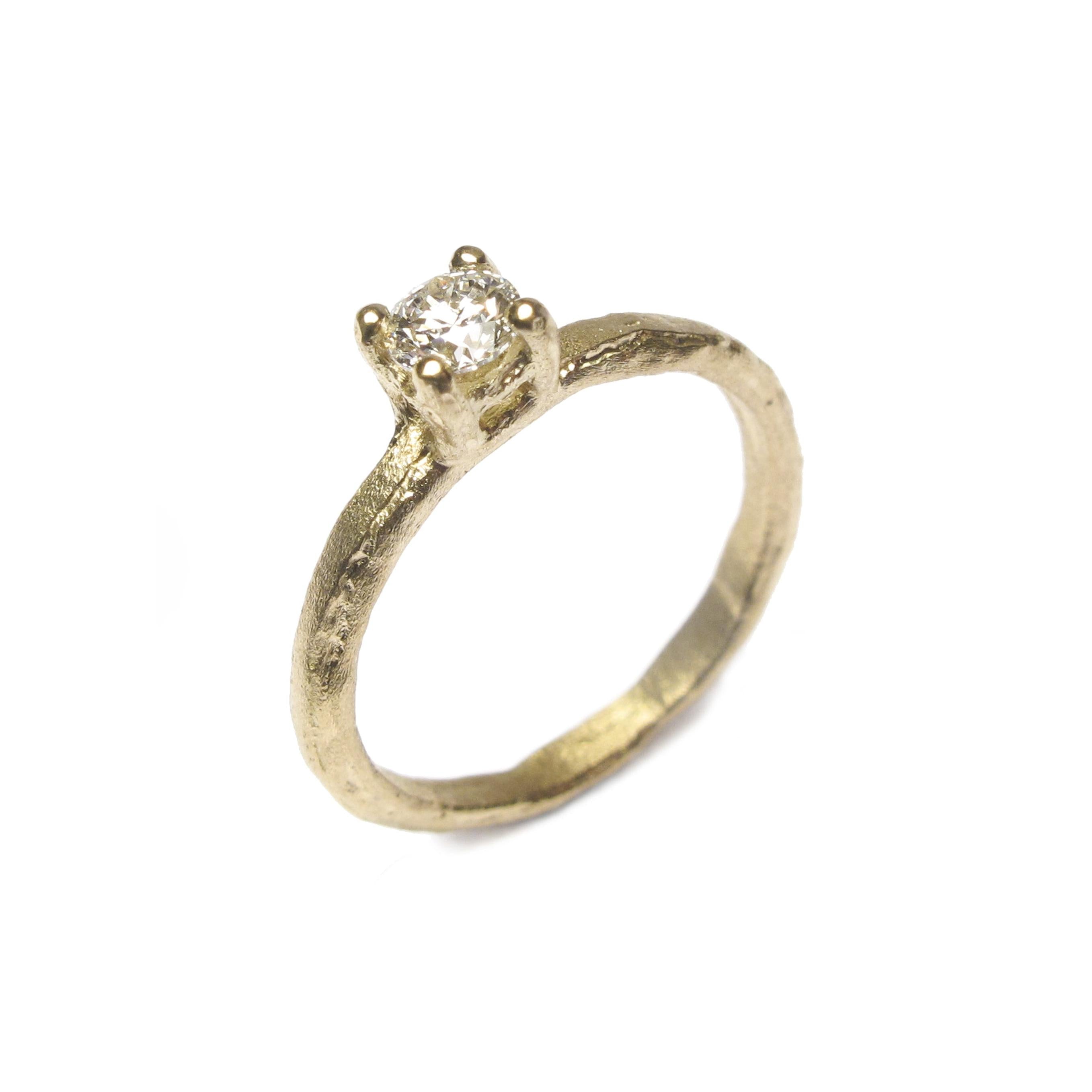 A textured yellow gold ring with a brilliant cut natural brown diamond in a claw setting on an etched Fairtrade 18ct ethical yellow gold band.