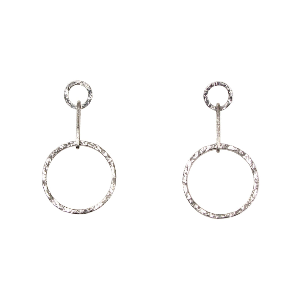 A pair of silver circle drop earrings with a hammered texture, hanging from small circular posts.