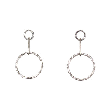 A pair of silver circle drop earrings with a hammered texture, hanging from small circular posts.