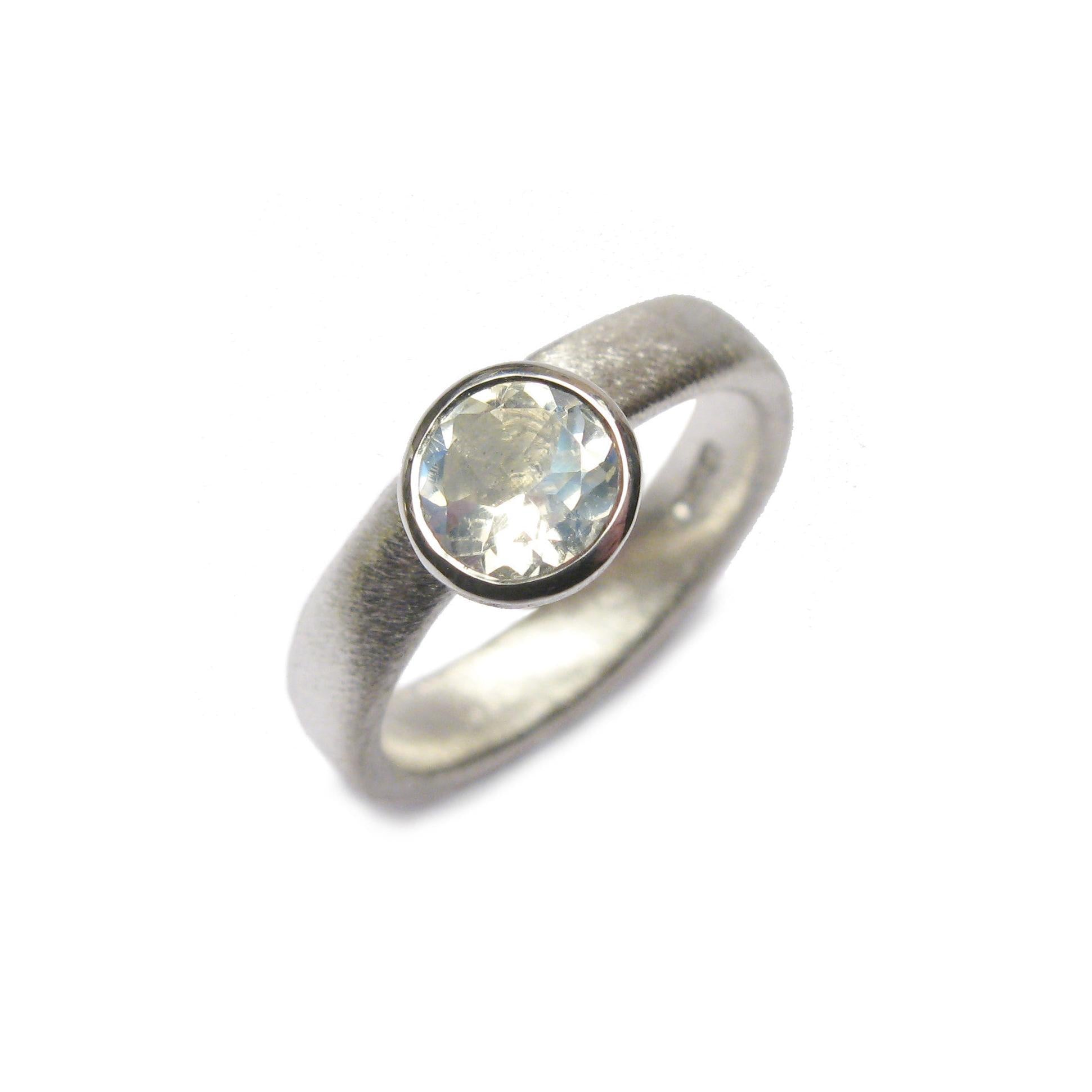 Bespoke silver ring set with a large, faceted moonstone.