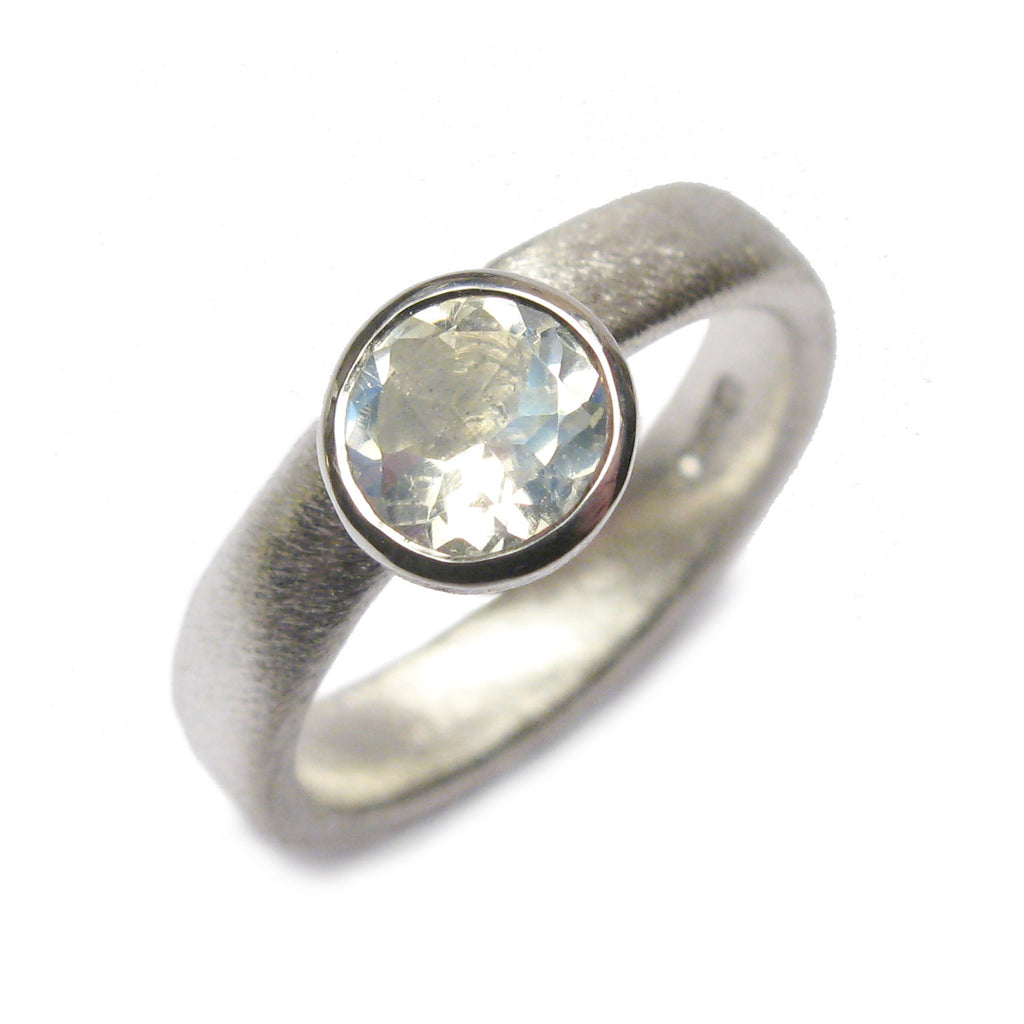 Bespoke silver ring set with a large, faceted moonstone.