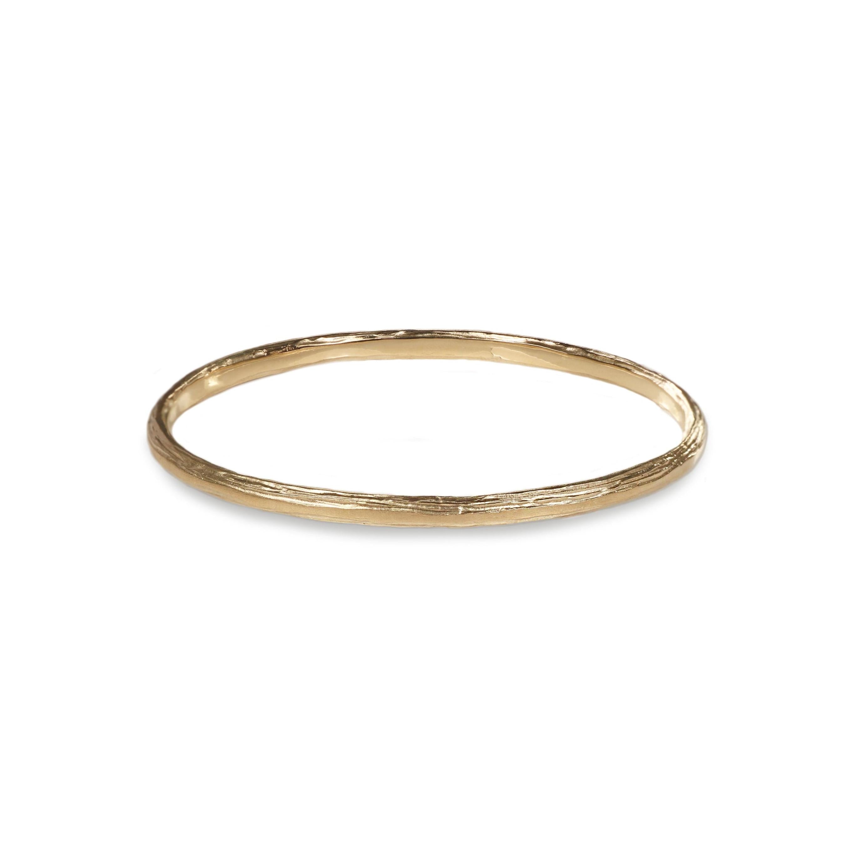 A 9ct Fairtrade yellow gold bangle with a textured etched finish.